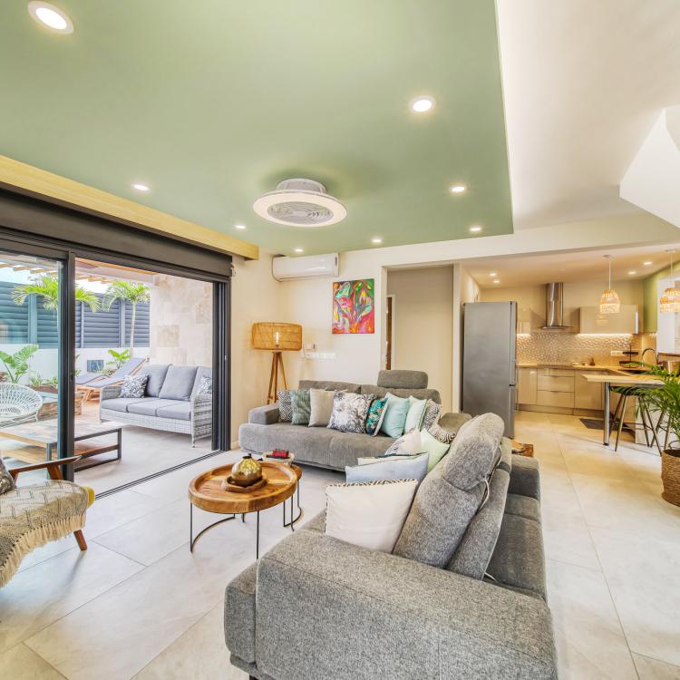 Living room with home cinema, view on american kitchen.